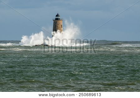 Giant Waves From A Unique High Tide Surround Stone Lighthouse Tower Of Whaleback Light As Sun Breaks
