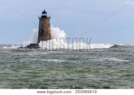 A Giant Wave From An Unusual High Tide Breaks Around Whaleback Lighthouse In Maine.