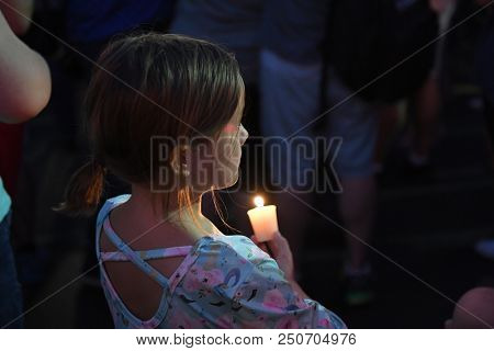Branson, MO, USA â July 20, 2018: Mourners gather on the parking lot of Ride the Ducks for a candlelight vigil to remember the victims of the boat accident.