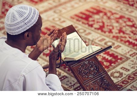 African Muslim Man Making Traditional Prayer To God While Wearing Dishdasha.