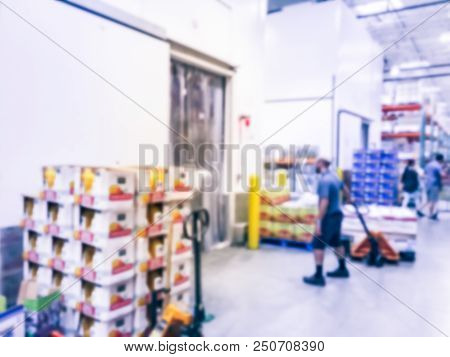 Worker With Manual Forklift Stockpile Goods Near Cold Storage Room In Wholesale Store