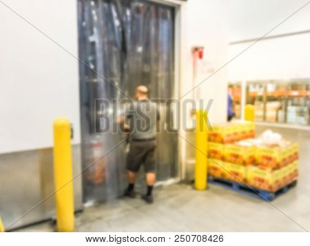Worker With Manual Forklift Stockpile Goods Near Cold Storage Room In Wholesale Store
