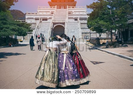 Group Friend Of Young Asian Woman Traveler Looking Photo In Smartphone In Korean National Dress Or H