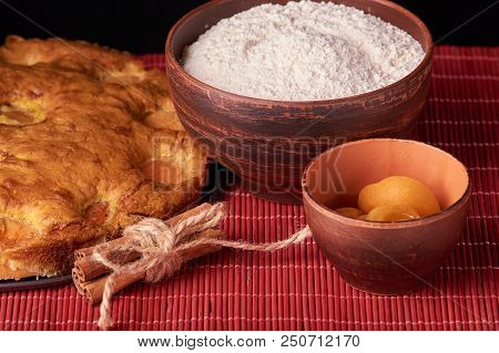On A Dark Wooden Table American Apricot Pie, Ingredients And Tools
