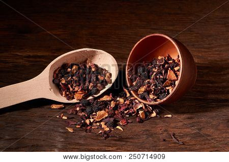Fruit Tea In A Clay Bowl On A Wooden Table And Black Background.