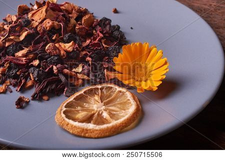 Dry Fruit Tea Flower And Lemon On Plate. Nice Red Wood Table