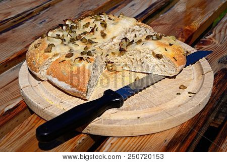 Homemade Italian Rosemary, Green Olive And Onion Focaccia Bread On A Wooden Board, England, Uk, Euro