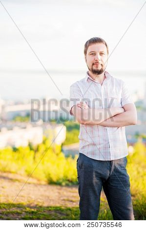 Portrait Of A Man In The Background Of Saratov, Russia, View Of The Houses, The Volga River, The Bri