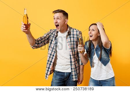 Young Irritated Couple Woman Man Sport Fan In Casual Clothes Cheer Up Support Team Holding Beer Bott