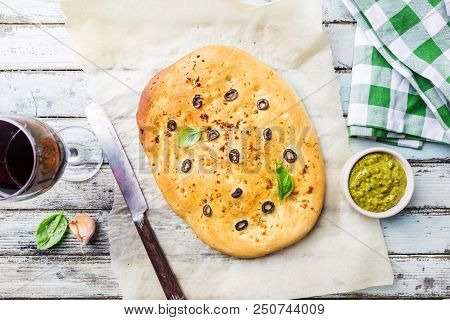 Traditional Italian Focaccia With Black Olives And Rosemary - Homemade Flat Bread Focaccia Over Wood
