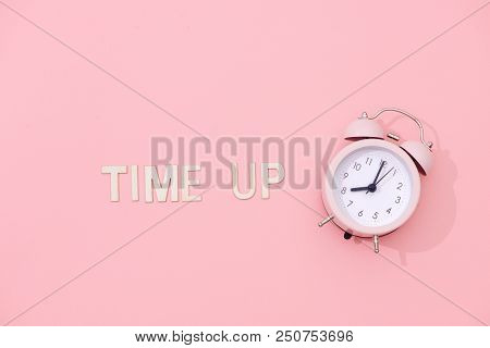 Time Up Text With Light Pink Retro Alarm Clock With Shadow On Pink Background.