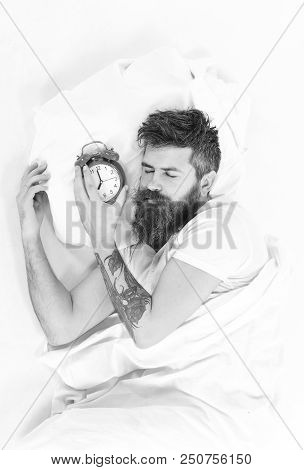 Man With Sleepy Face Lies On Pillow Near Alarm Clock. Hipster With Beard And Mustache Sleep. Morning