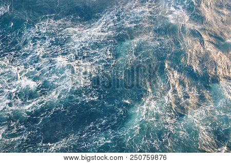 Surface Of Sea Water. Blue Cold Frothy Wavy Aqua Background. Open Deep Sea, View From Above.
