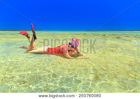 Happy Caucasian Woman With Snorkeling Wetsuit, Mask And Fins Pink And Peach Color, Sunbathing Lying 