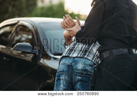 Police officer arrests the driver violator on road
