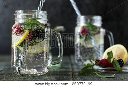 A Cooling Lemon Drink In A Glass Cup On A Wooden Table