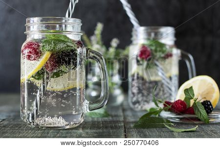 A Cooling Lemon Drink In A Glass Cup On A Wooden Table