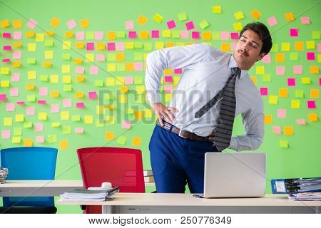 Man in the office with many conflicting priorities doing exercis