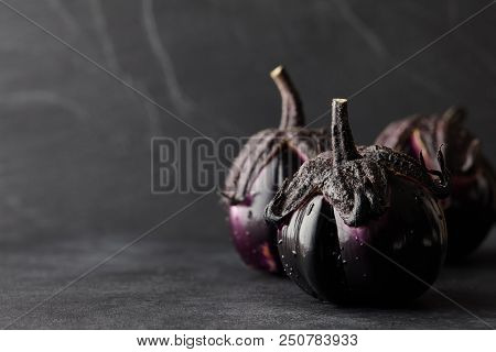 Fresh Italian Type Eggplants Or Aubergines With Water Drops Closeup On Black Background