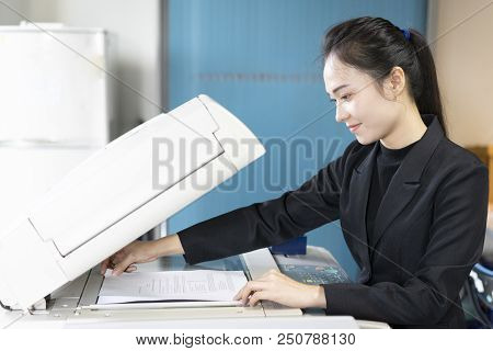 Woman Secretary Hand Putting A Sheet Of Paper Into A Copying Device