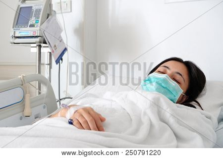Close Up Young Woman Patient Lay On Bed In Hospital With Intravenous Normal Saline