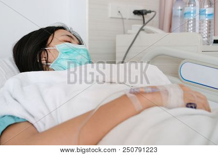 Close Up Young Woman Patient Lay On Bed In Hospital With Intravenous Normal Saline