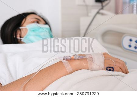 Close Up Young Woman Patient Lay On Bed In Hospital With Intravenous Normal Saline