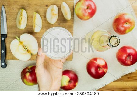 Flat Lay With Glass Of Sparkling Cidre Drink On Rustic Wooden Table. Point Of View Of Hand Holding G