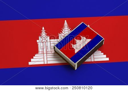 Cambodia Flag  Is Pictured On A Matchbox That Lies On A Large Flag.