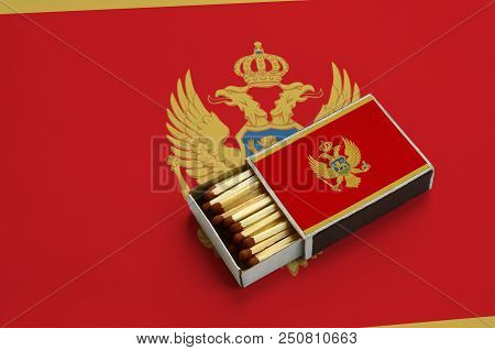 Montenegro Flag  Is Shown In An Open Matchbox, Which Is Filled With Matches And Lies On A Large Flag