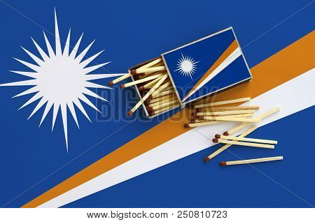 Marshall Islands Flag  Is Shown On An Open Matchbox, From Which Several Matches Fall And Lies On A L