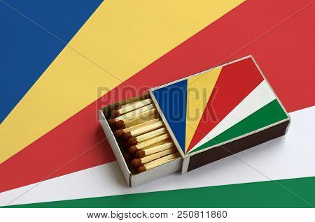 Seychelles Flag  Is Shown In An Open Matchbox, Which Is Filled With Matches And Lies On A Large Flag
