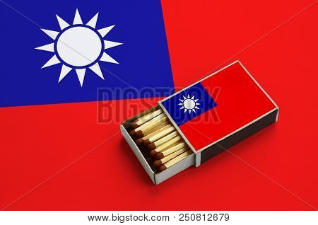 Taiwan Flag  Is Shown In An Open Matchbox, Which Is Filled With Matches And Lies On A Large Flag.