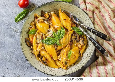 Pasta Conchiglioni With Mushrooms In A Vintage Bowl On A Dark Stone Or Concrete Background. Top View