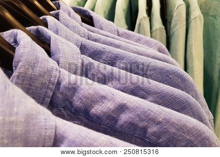 Men's Blue Colored Shirts On The Vases At The Retailer.