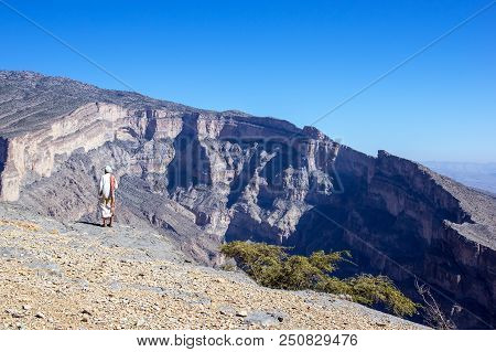 Omani Man Standing On The Edge Of The Jebel Shams - Sultanate Of Oman
