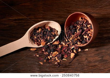 Raspberry Tea In Brown Clay Bowl. Wooden Background.