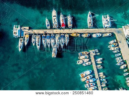 Top down aerial view of sailboats and yachts anchored in harbor at Paros Island, Greece