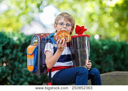 Happy Little Kid Boy With Glasses And Backpack Or Satchel On His First Day To School . Child Outdoor