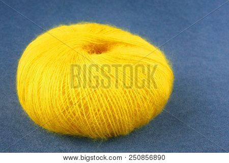 Yellow Yarn Ball Of Mohair (angora) Wool For Knitting On The Velvet Background. Front View.
