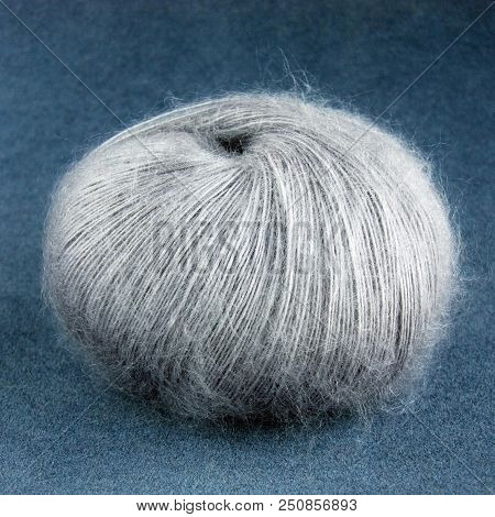 Grey Yarn Ball Of Mohair (angora) Wool For Knitting On The Velvet Background. Front View.