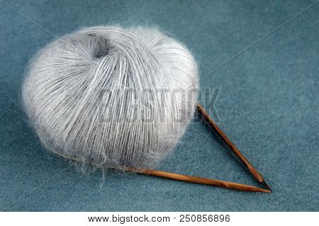 Grey Yarn Ball Of Mohair (angora) Wool For Knitting With Knitting Needles  
On The Velvet Background