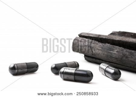 Charcoal (activated Carbon) In Capsules On White Background