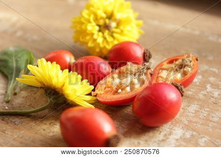 Rosehip Berries On Wooden Background. Autumn Composition. Useful Tea Ingrid.