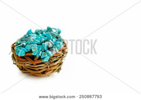 Pile Stones Of Raw Turquoise In Small Wooden Nest On A White Background. Blue And Green Color Stones