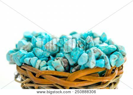 Pile Stones Of Raw Turquoise In Small Wooden Nest On A White Background. Blue And Green Color Stones