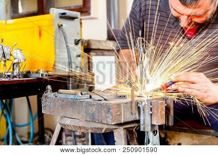 Sculptor Is Using Arc Welding To Assembly Metal Sculpture Without Proper Protection, Barehanded.