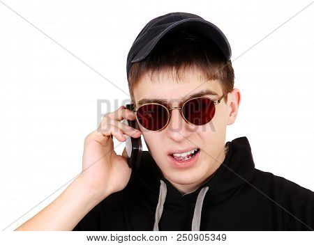 Stressed Young Man Speak On The Phone Isolated On The White Background