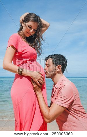 Happy Young Man Father Kising Girl`s Stomach. Pregnancy New Life Concept