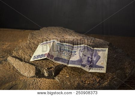 Turkish Old Banknote On The Stone And Dark Background